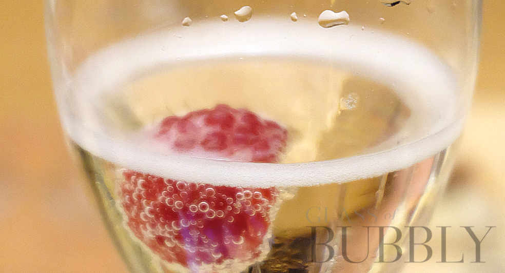 glass of bubbly prosecco raspberry