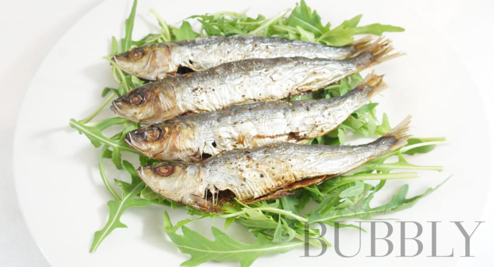 Sardines seasoned with black pepper and also a squeeze of lemon